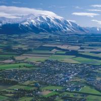 View of the Canterbury plains and Methven bordered by the stunning South Island Southern Alps 